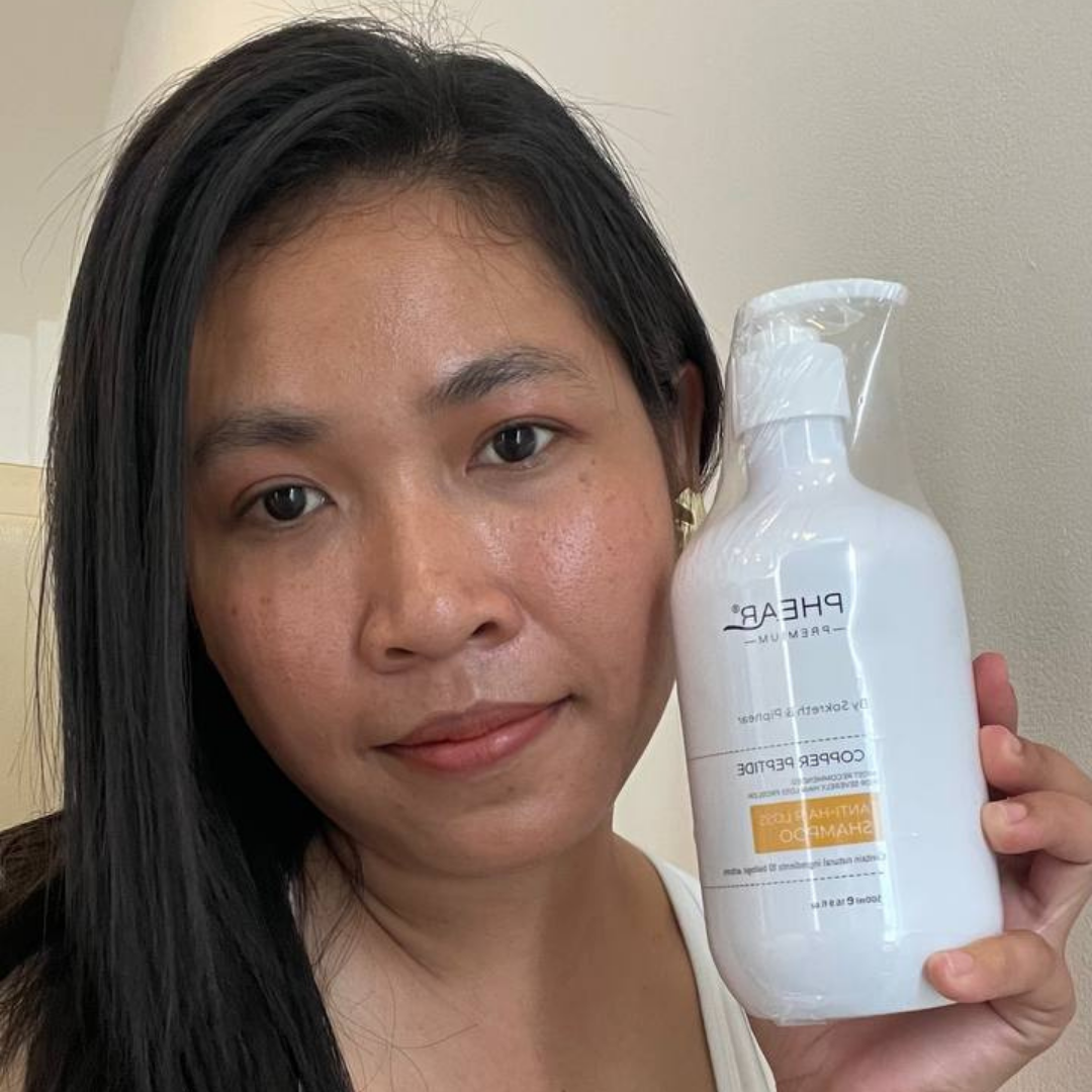 Person holding a bottle of Pharederm product