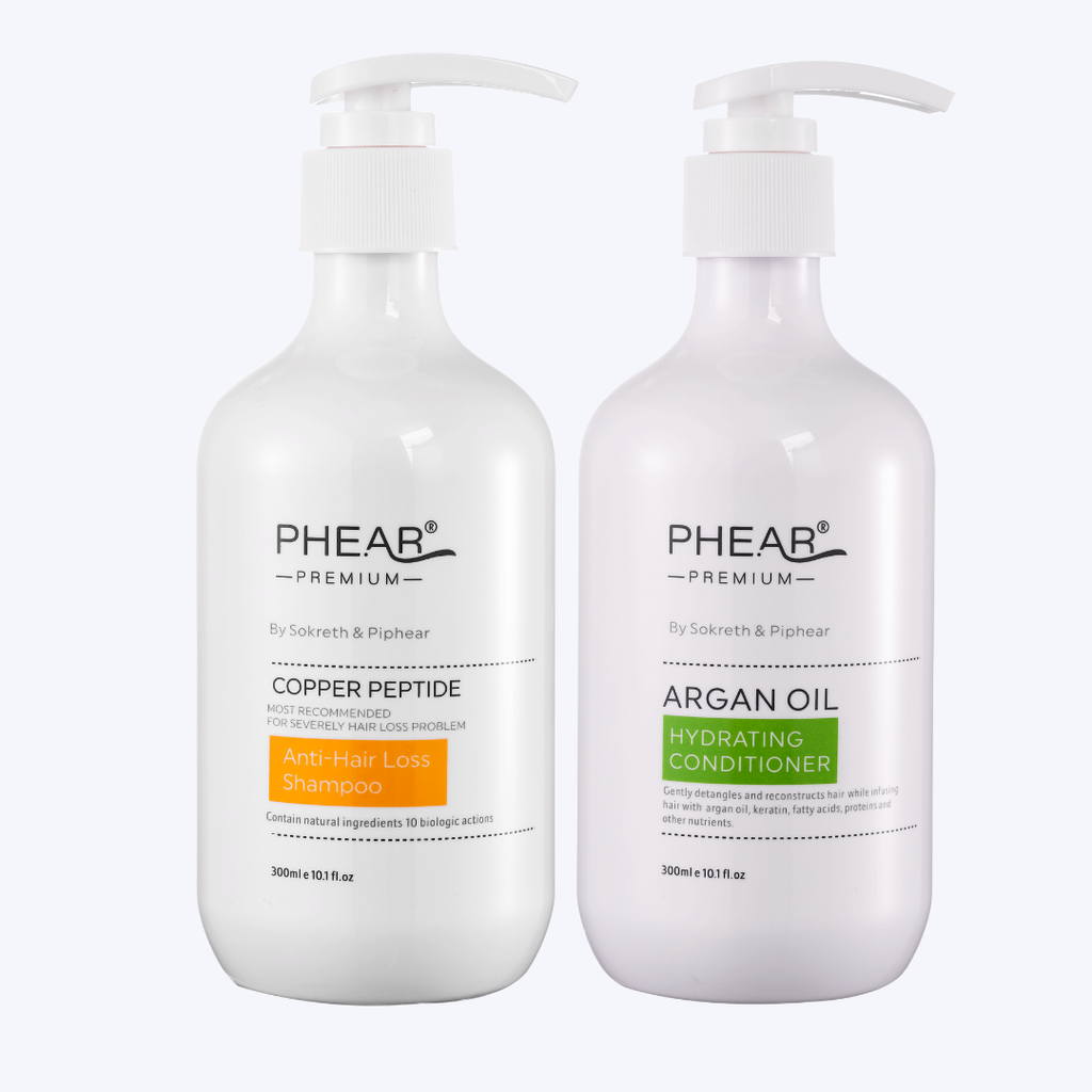 Two bottles of Phear hair care products on a white background