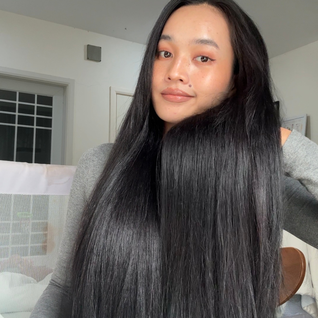 A beautiful woman with long black hair in a casual indoor